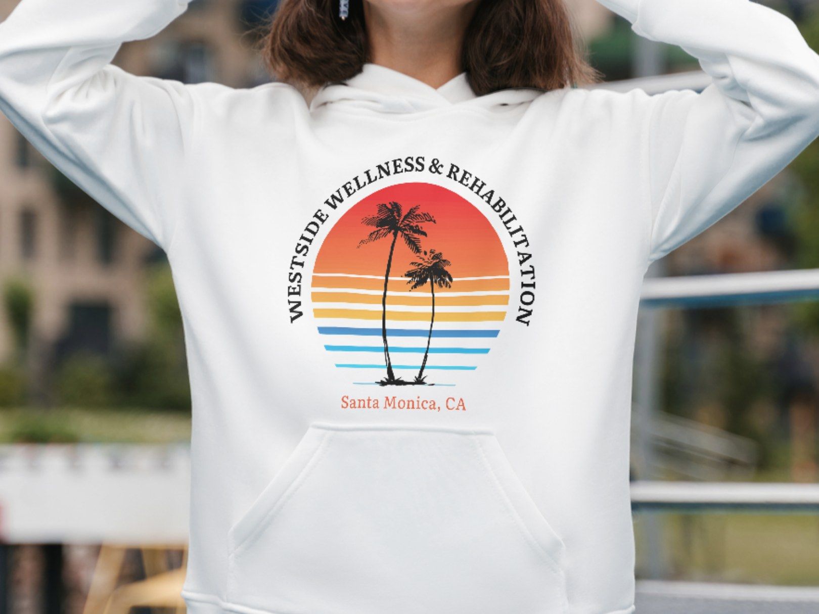 The Westside Wellness & Rehabilitation logo printed on the front of a white hoodie